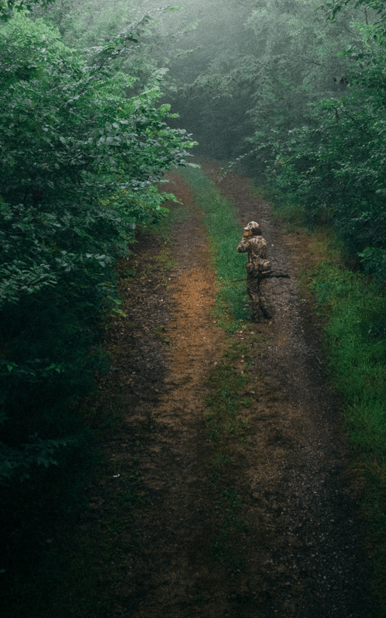 Beau Brooks walking down a dirt road turkey calling with the Turkey Tool Belt | SITKA Gear