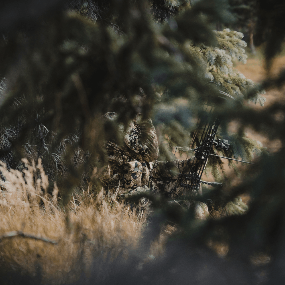Man in Optifade Subalpine elk hunting sitting in vegetated terrain waiting | SITKA Gear