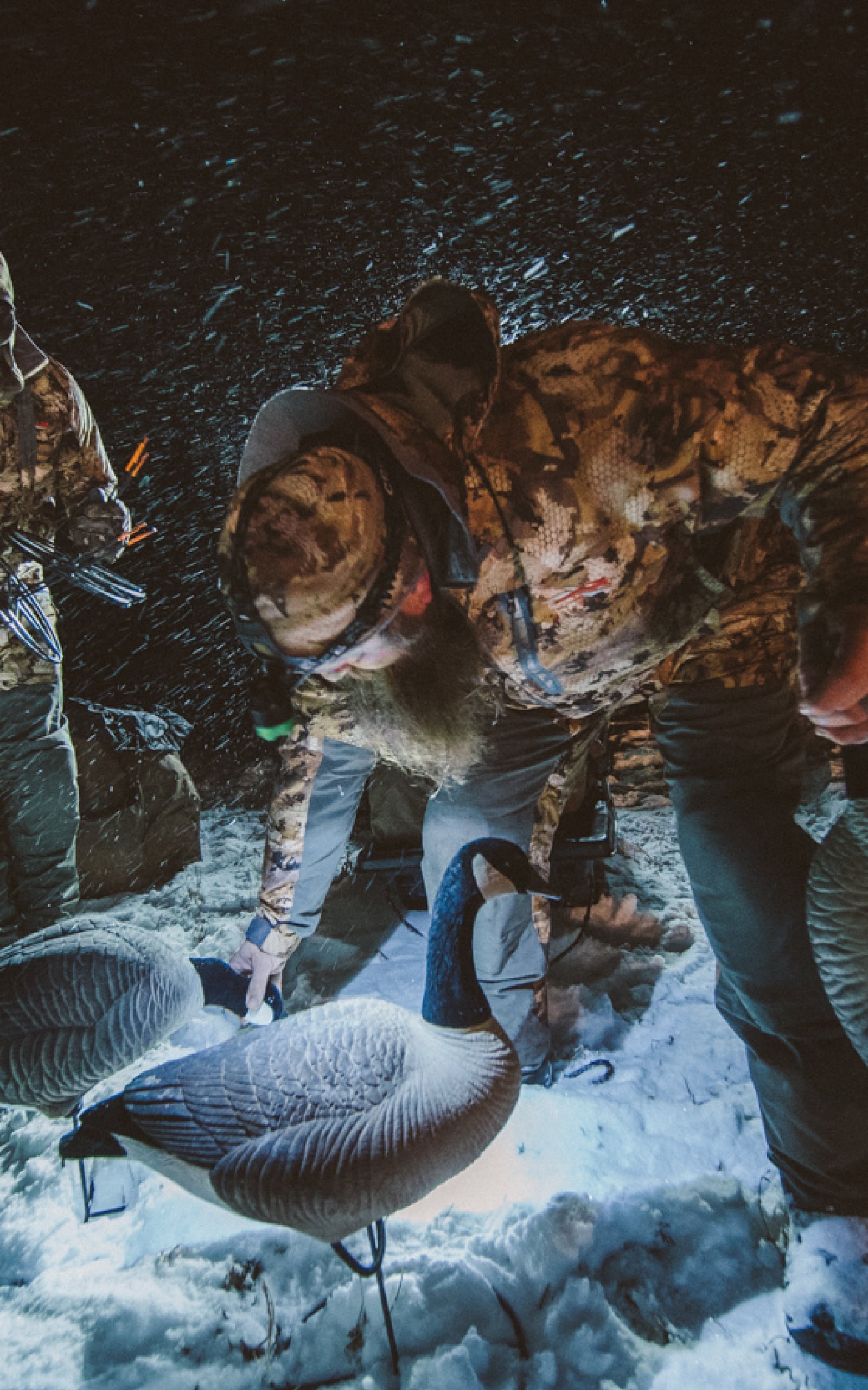 Man setting a decoy spread in cold, wet, snowy weather | SITKA Gear