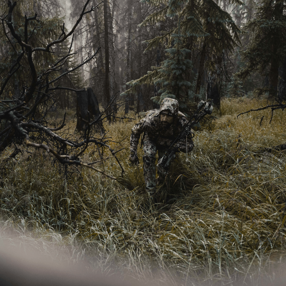 Man in Optifade Subalpine elk hunting staling in vegetated terrain | SITKA Gear